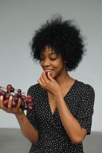 woman eating fresh grapes